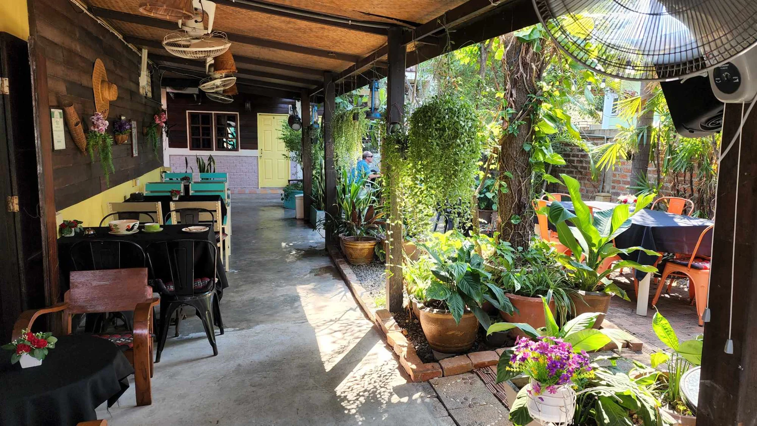 Covered outdoor seating and garden at The Outside Inn